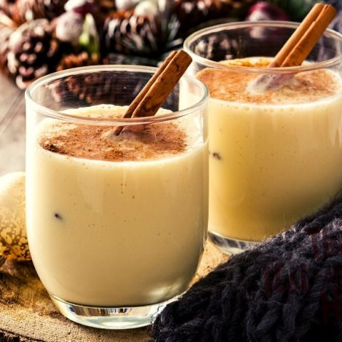 Eggnog with ground nutmeg and a cinnamon stick