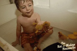 Our New Ducklings | The Not so Modern Housewife boy playing in bathtub with baby ducklings