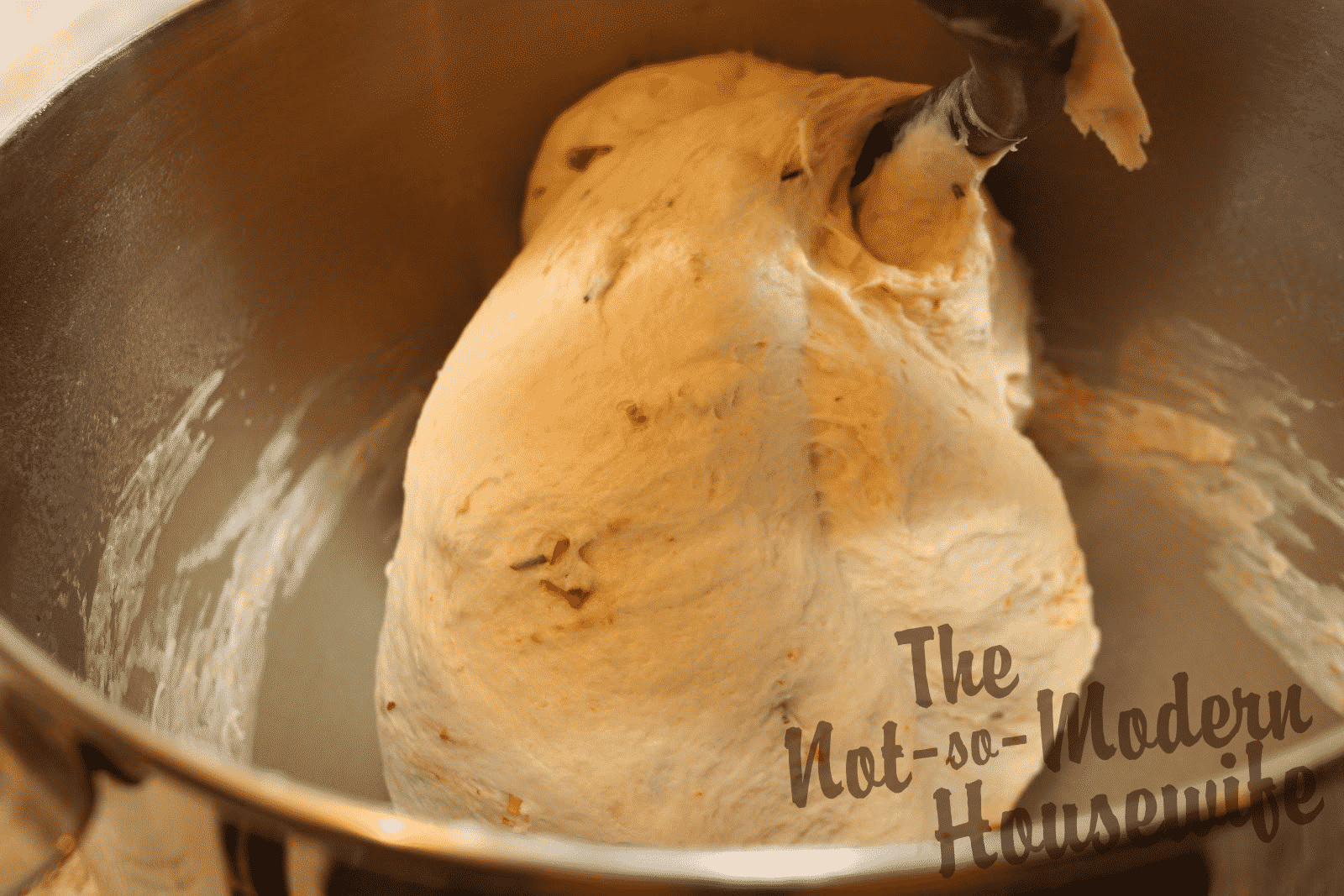 Italian Sun-dried Tomato Ciabatta | The Not So Modern Housewife mixing in bread dough flavors