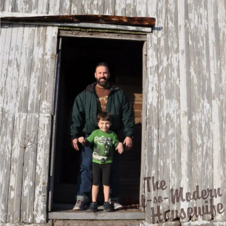 4 Big Reasons Why I Chose to Become a Homesteader | The Not so Modern Housewife father and son standing in the doorway of an old barn on a homestead