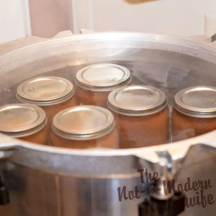 Delicious Restaurant Style Homemade Salsa Recipe with 4 Tips for Water Bath Canning | The Not So Modern Housewife processing jars of homemade salsa in a water bath canner - how to can salsa at home