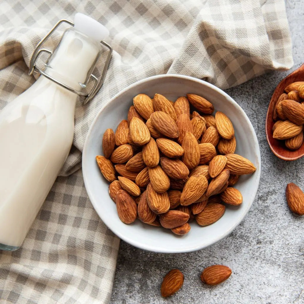 Milk with a bowl of almonds for rice pudding