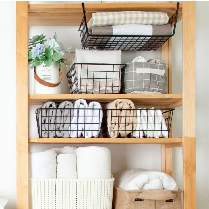 organized shelves using wire and cloth baskets to organize clothes - clothing organization ideas