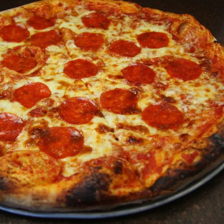 pepperoni pizza freshly baked on a pizza pan - sourdough pizza dough